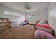Carpeted bedroom featuring white walls, multiple windows and a ceiling fan at 4320 Teller St, Wheat Ridge, CO 80033