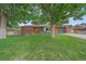 Charming brick home with a well-manicured lawn and mature trees at 4320 Teller St, Wheat Ridge, CO 80033