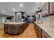 Gourmet kitchen with granite countertops, hardwood floors, and stainless-steel appliances at 4320 Teller St, Wheat Ridge, CO 80033