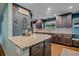 Stylish kitchen with a granite-topped island, custom cabinets, and elegant decor at 4320 Teller St, Wheat Ridge, CO 80033