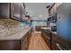 Eat in kitchen showcases modern appliances, granite countertops and wood flooring at 4320 Teller St, Wheat Ridge, CO 80033