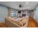 Comfortable living room features a fireplace, a large window, and a plush sectional sofa at 4320 Teller St, Wheat Ridge, CO 80033