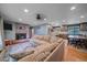 Spacious living room with hardwood floors and a fireplace, connected to a dining area and kitchen at 4320 Teller St, Wheat Ridge, CO 80033
