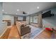 Cozy living room with hardwood floors, a large window, and a comfortable sectional sofa at 4320 Teller St, Wheat Ridge, CO 80033
