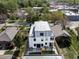 Aerial view showcasing the modern home with rooftop deck and fenced backyard at 1543 Glencoe St, Denver, CO 80220