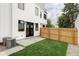 Charming backyard features a small lawn, privacy fence, and a patio perfect for relaxing outdoors at 1543 Glencoe St, Denver, CO 80220