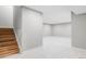 View of finished basement with carpet, new paint and wooden staircase at 1543 Glencoe St, Denver, CO 80220