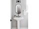Elegant bathroom with pedestal sink, stylish fixtures, and a modern oval mirror at 1543 Glencoe St, Denver, CO 80220