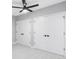 Bedroom with light gray carpet, a ceiling fan, and bright white closet doors at 1543 Glencoe St, Denver, CO 80220