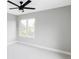 Bright bedroom featuring light grey walls, a ceiling fan, plush carpet, and a view from the window at 1543 Glencoe St, Denver, CO 80220