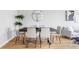 Contemporary dining room features a dark wood table and six modern chairs, perfect for gatherings at 1543 Glencoe St, Denver, CO 80220