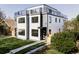 Modern two-story home with black trim windows, fresh lawn, and a rooftop deck at 1543 Glencoe St, Denver, CO 80220