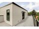 Exterior corner of home with clean lines, modern lighting, and a spacious deck at 1543 Glencoe St, Denver, CO 80220
