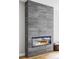 Modern fireplace with marble tile surround, showcasing sleek design and ambient lighting at 1543 Glencoe St, Denver, CO 80220