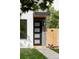 Modern front door with glass panels, sleek hardware, and a contemporary wooden fence at 1543 Glencoe St, Denver, CO 80220