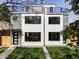 Contemporary two-story house featuring a manicured lawn, modern windows, and sleek design at 1543 Glencoe St, Denver, CO 80220