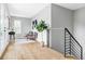 An upstairs living area features stylish furniture, artwork and a staircase with metal railings at 1543 Glencoe St, Denver, CO 80220