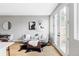 Comfortable living room with stylish decor, including plush seating and unique artwork at 1543 Glencoe St, Denver, CO 80220