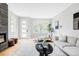Bright living room featuring modern furnishings, hardwood floors, a marble fireplace, and large windows at 1543 Glencoe St, Denver, CO 80220