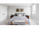 Serene main bedroom with soft gray tones, decorative pillows, and cozy bench at 1543 Glencoe St, Denver, CO 80220