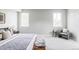 Bright main bedroom features natural light, a comfortable chair, and stylish bench seating at 1543 Glencoe St, Denver, CO 80220
