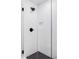 Close up view of a tiled shower with matte black hardware and built in shower niche at 1543 Glencoe St, Denver, CO 80220