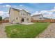 Expansive backyard featuring a well-maintained lawn and a charming patio area at 2510 E 160Th Pl, Thornton, CO 80602