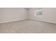 Carpeted basement room with a window, offering ample space and natural light at 2510 E 160Th Pl, Thornton, CO 80602