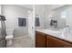 Well-lit bathroom with a single vanity, tiled floors, and a shower/tub combo with white tiling at 2510 E 160Th Pl, Thornton, CO 80602