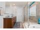 Bathroom featuring a soaking tub, walk-in shower, and double vanity sink at 2510 E 160Th Pl, Thornton, CO 80602