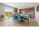 Open dining area featuring modern lighting, wood floors, and large windows to the backyard at 2510 E 160Th Pl, Thornton, CO 80602