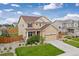 Inviting two-story home with a manicured lawn, showcasing a large garage and charming curb appeal at 2510 E 160Th Pl, Thornton, CO 80602
