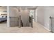 Upstairs hallway showcasing carpeted floors, decorative railing, and access to multiple rooms at 2510 E 160Th Pl, Thornton, CO 80602