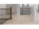 Second floor hallway with carpeted floors and decorative railing, offering access to other rooms at 2510 E 160Th Pl, Thornton, CO 80602
