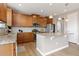 Well-equipped kitchen with granite countertops, wood cabinets, stainless steel appliances, and an island at 2510 E 160Th Pl, Thornton, CO 80602