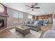 Spacious living room with a fireplace that opens up to the dining area and kitchen at 2510 E 160Th Pl, Thornton, CO 80602