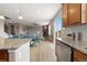Open concept floor plan showcasing living room with fireplace, dining room, and kitchen at 2510 E 160Th Pl, Thornton, CO 80602