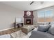 Cozy living room with a fireplace, plush seating, and plenty of natural light at 2510 E 160Th Pl, Thornton, CO 80602