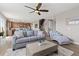 Open-concept living room with wood floors, a staircase, and plenty of natural light at 2510 E 160Th Pl, Thornton, CO 80602