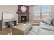 Cozy living room with a fireplace, comfortable seating, and natural light at 2510 E 160Th Pl, Thornton, CO 80602