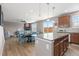 Bright open floor plan with living, dining, and kitchen areas, wood floors, and outdoor access at 2510 E 160Th Pl, Thornton, CO 80602