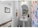 Stylish powder bathroom with decorative wallpaper and a pedestal sink at 4419 N Quatar Ct, Aurora, CO 80019
