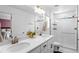 Bright primary bathroom with double sinks and a glass-enclosed shower at 4419 N Quatar Ct, Aurora, CO 80019