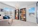 Bright bedroom featuring carpeted floors, two bookcases and large windows at 4419 N Quatar Ct, Aurora, CO 80019