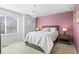 Cozy bedroom with a neutral color scheme, bedside tables with lamps, and large window at 4419 N Quatar Ct, Aurora, CO 80019