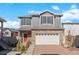 Beautiful two-story home with a stone facade, gray siding and well manicured lawn at 4419 N Quatar Ct, Aurora, CO 80019