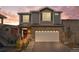 Beautiful two-story home with a stone facade, gray siding and well manicured lawn at 4419 N Quatar Ct, Aurora, CO 80019
