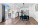 Modern kitchen features stainless appliances, gray backsplash, center island with seating, and sliding doors to the patio at 4419 N Quatar Ct, Aurora, CO 80019