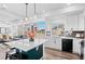 Bright kitchen open to the living room features a large center island with seating and stainless steel appliances at 4419 N Quatar Ct, Aurora, CO 80019