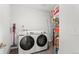 Efficient laundry room featuring a washer, dryer, and storage shelves at 4419 N Quatar Ct, Aurora, CO 80019